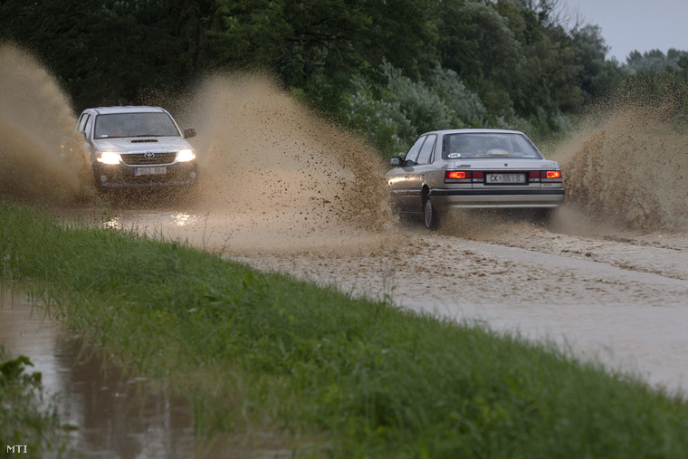 Autók haladnak a Zala megyei Letenye és Tornyiszentmiklós közötti vízzel borított úton 