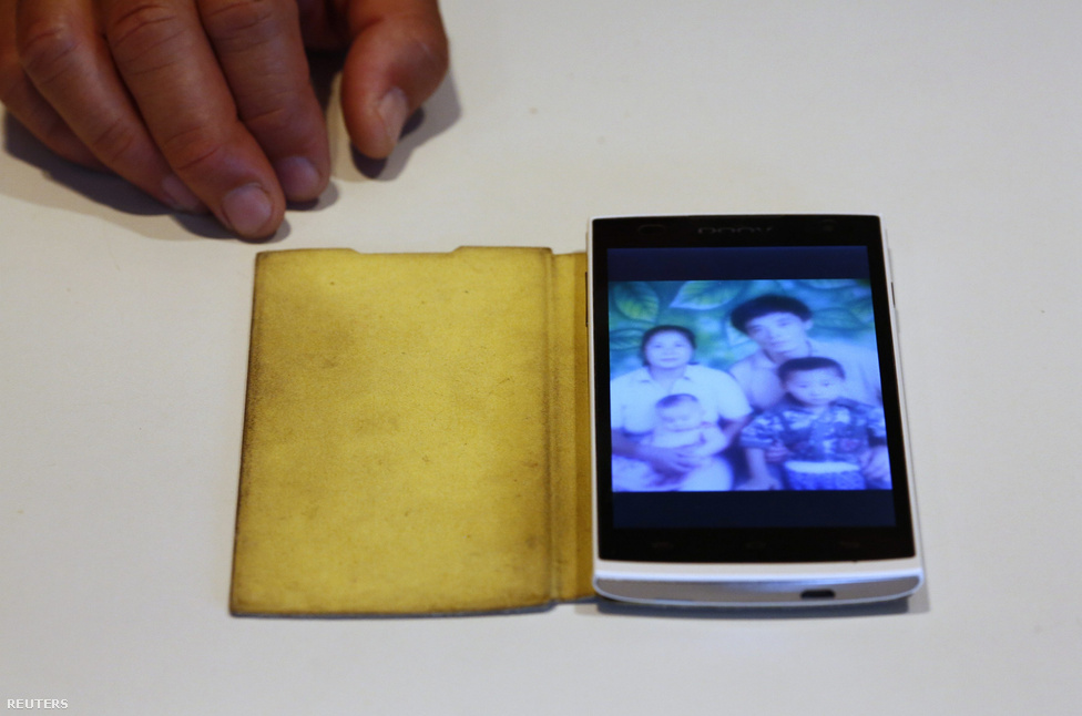Liu Kun családi fotója a mobiltelefonján.  Liu fiatalabb bátyját vesztette el, akivel a képen együtt szerepel gyerekkorában.