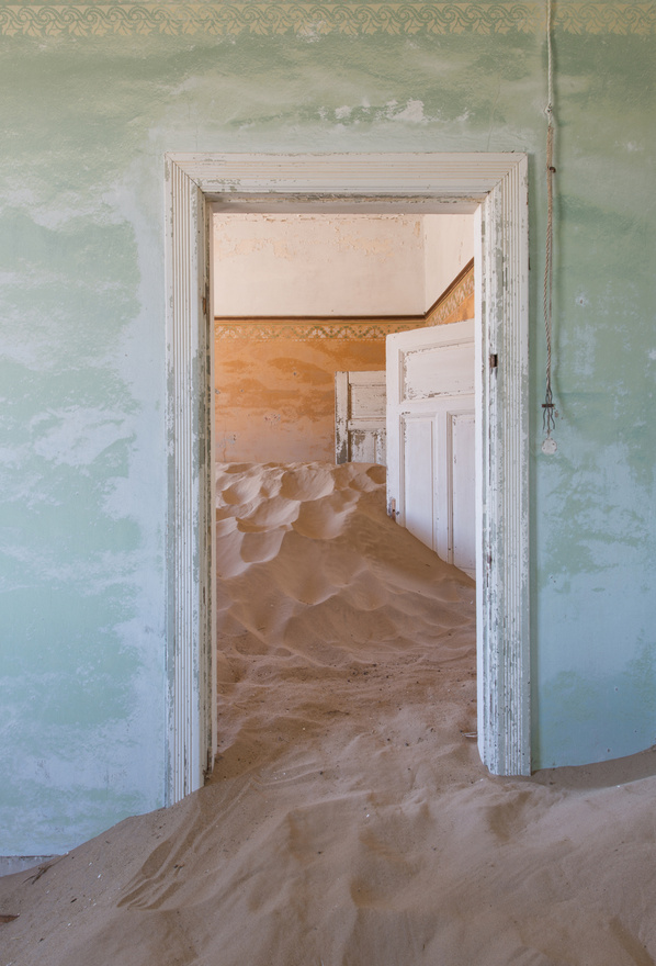 "Számomra ezek az ajtók az elkerülhetetlenül múló idő szimbólumai, amik arra emlékeztetnek, hogy Kolmanskop hamarosan nem lesz többé" – mondja a képekről a fotók készítője, Romain  Veillon.