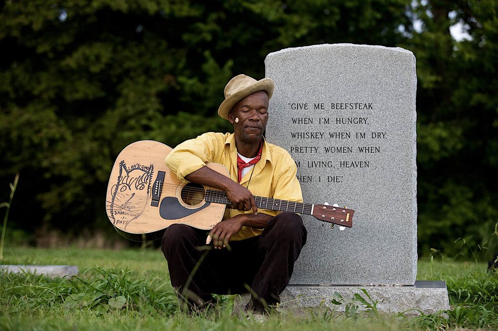 Lou Bopp mindenképpen úgy képzelte el a portréit, hogy a veterán bluesgitárosokat a saját otthonukban, természetesen környezetükben fotózza le, így Pat Thomas fotója alig pár méterre édesapja sírja mellett készült. James "Son" Thomas legendás blueszenész volt, fia, Pat az apja számait játszva próbálja megtartani a férfi emlékét. 
