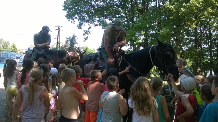 Ezen a képen a miskolci gyerekek a Miskolci Önkormányzati Rendészet mezőőri szolgálatától érkezett lovas mezőőrök lovaival ismerkednek